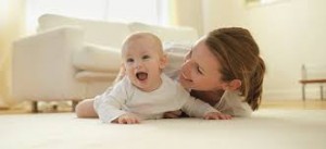 Mother and baby on carpet